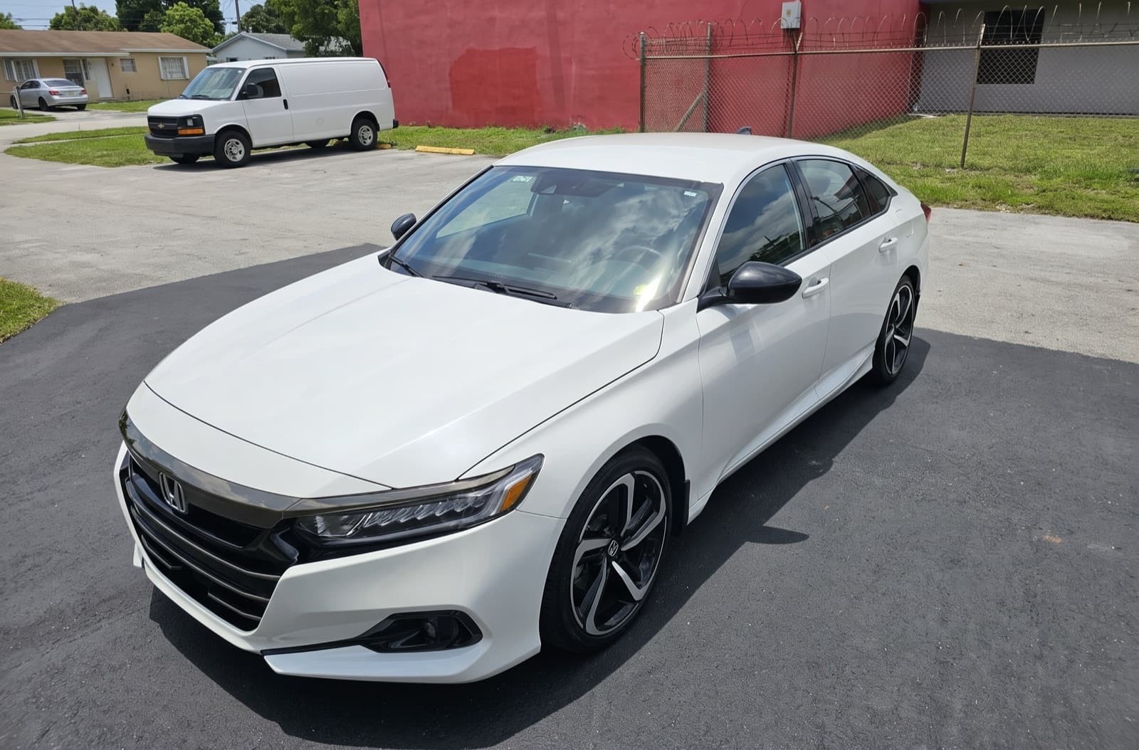 A white sedan in a parking lot in Miami Gardens, FL, after a Bang AutoGlass mobile glass job